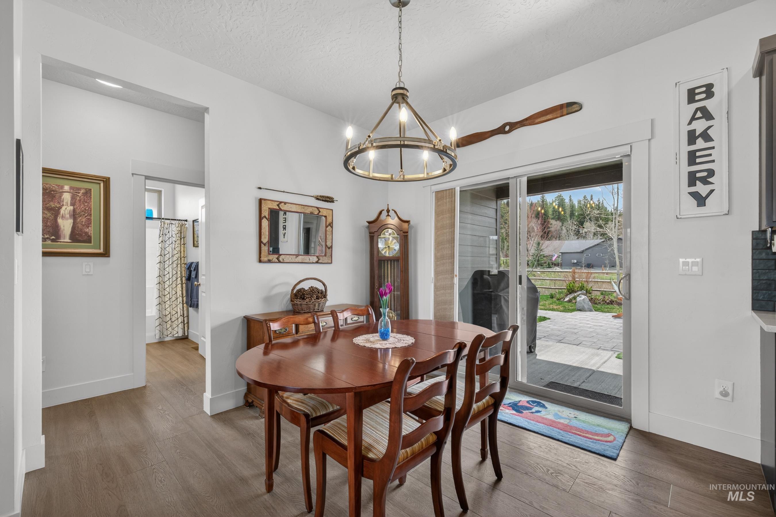 1126 Mo's Way McCall, ID 83638 - Photo 19 of 50 Dining area with wood-finish flooring and a contemporary chandelier