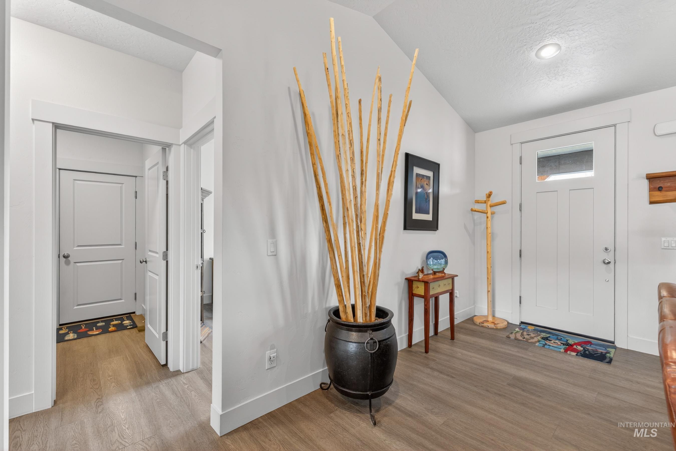 1126 Mo's Way McCall, ID 83638 - Photo 20 of 50 Entryway featuring wood-finish flooring, white trim, recessed lighting, and a white paneled door with glass insert