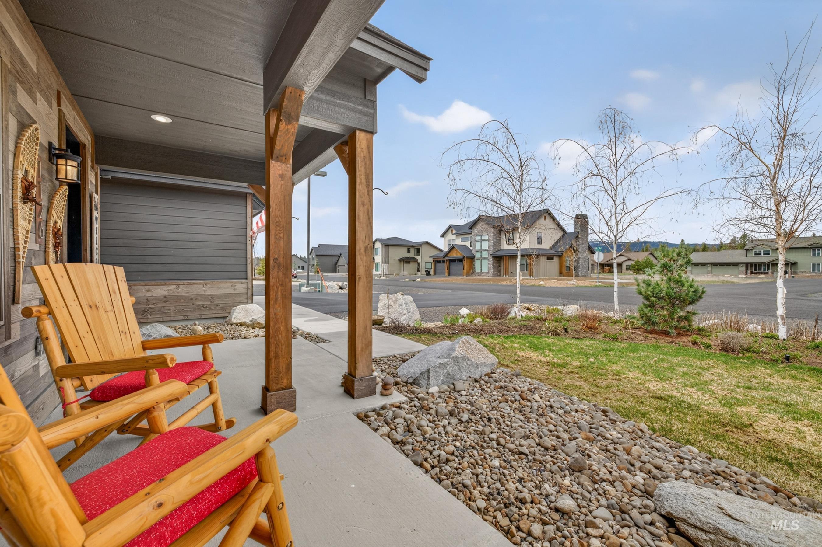 1126 Mo's Way McCall, ID 83638 - Photo 2 of 50 Covered front porch featuring wood-clad siding, exposed wood columns, recessed lighting, and a concrete surface