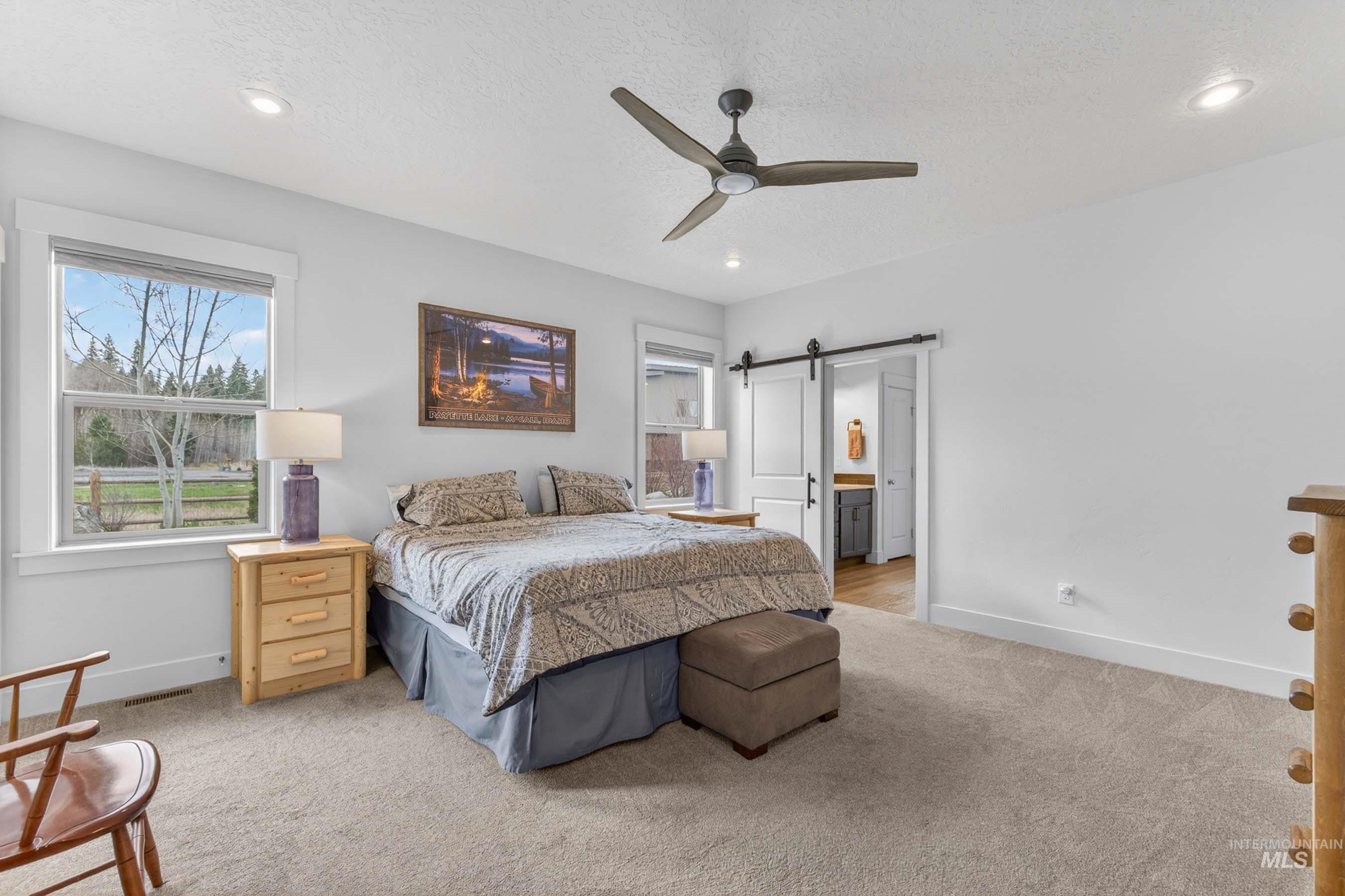 1126 Mo's Way McCall, ID 83638 - Photo 22 of 50 Carpeted bedroom featuring white walls, recessed lighting, and a contemporary ceiling fan
