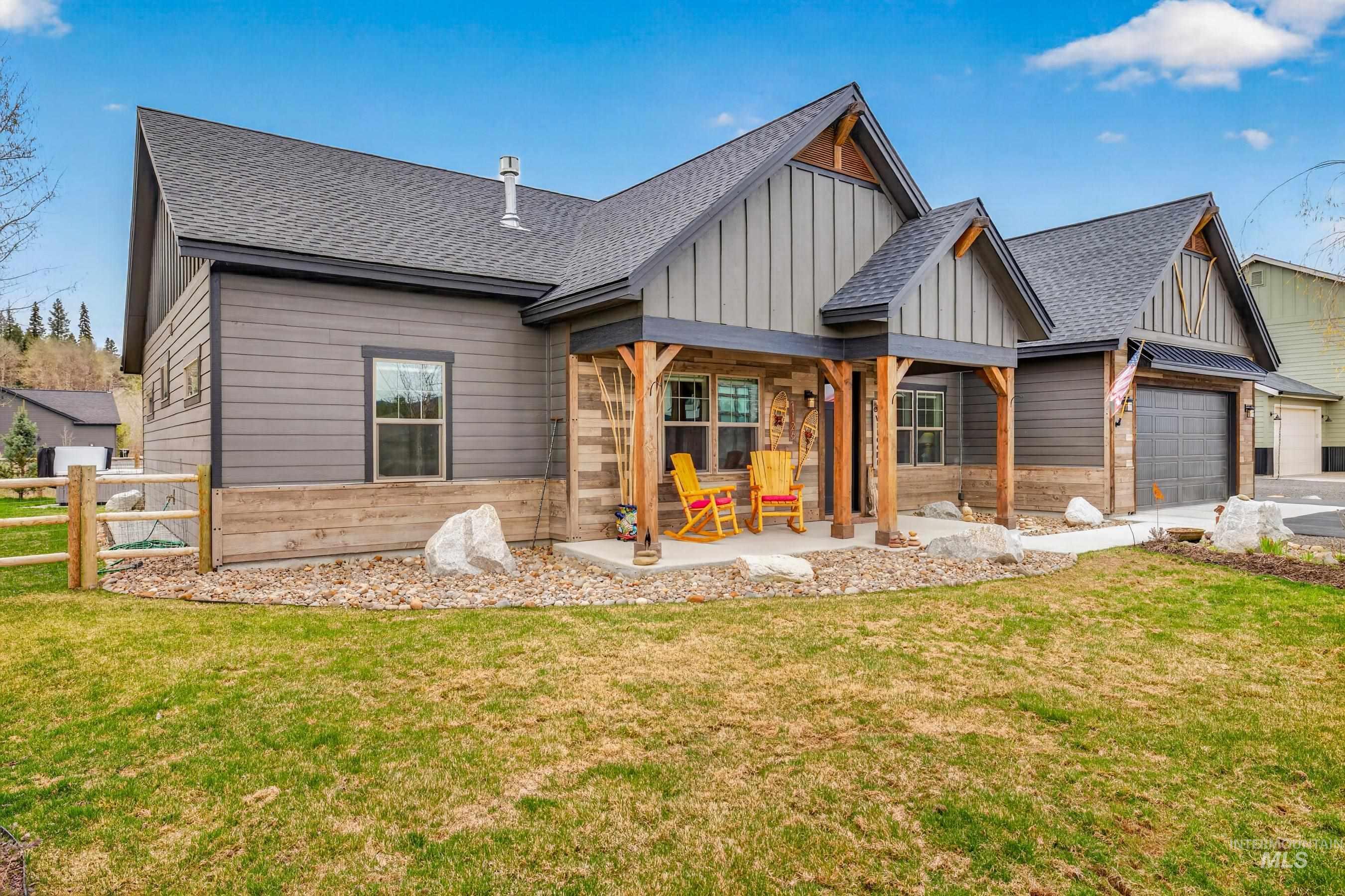 1126 Mo's Way McCall, ID 83638 - Photo 46 of 50 Craftsman-style home featuring a covered front porch with timber columns, board and batten gables, horizontal siding, and an attached two-car garage