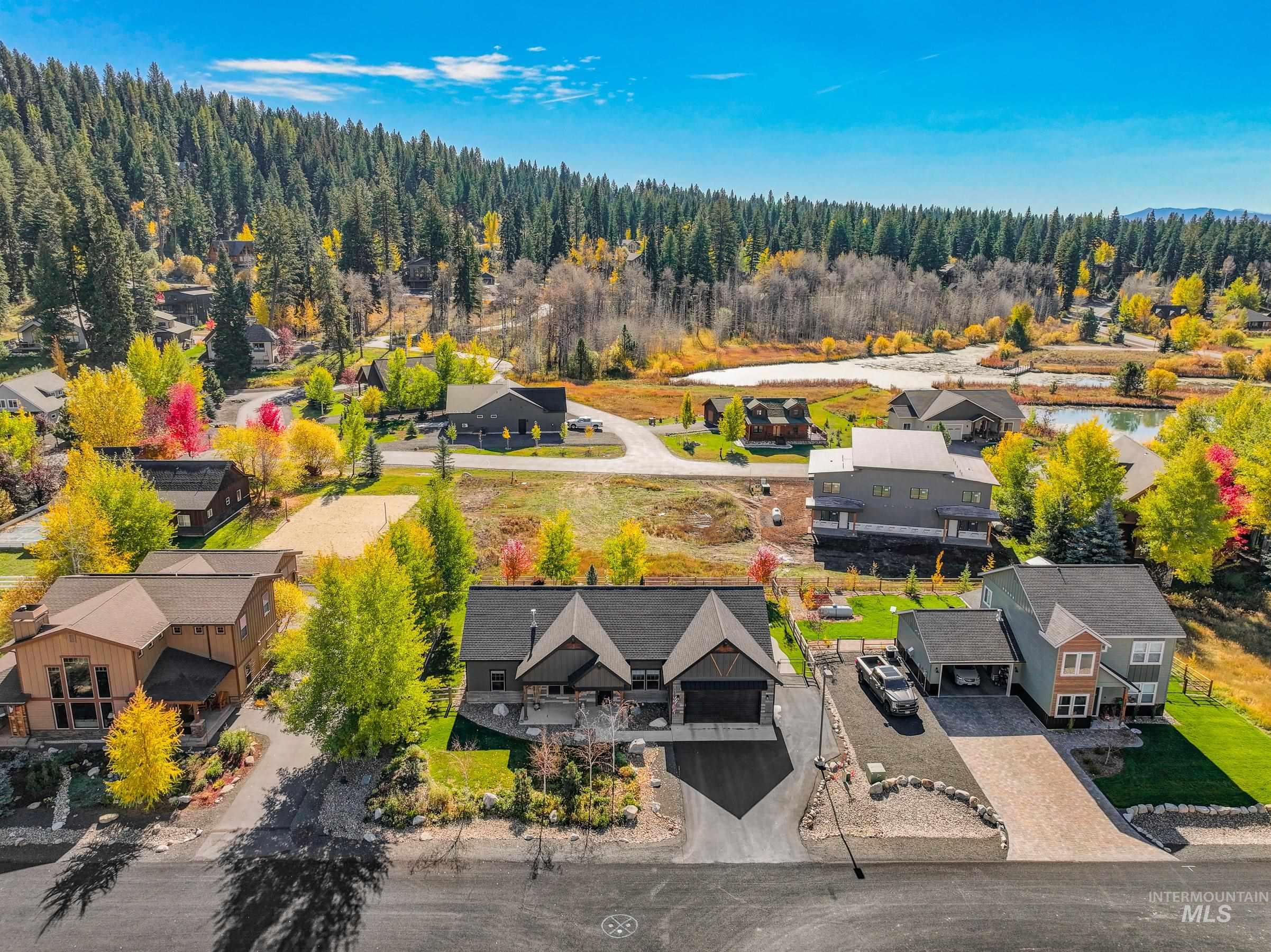 1126 Mo's Way McCall, ID 83638 - Photo 47 of 50 Modern craftsman-style home featuring a two-car garage, dark gray siding, and a paved driveway