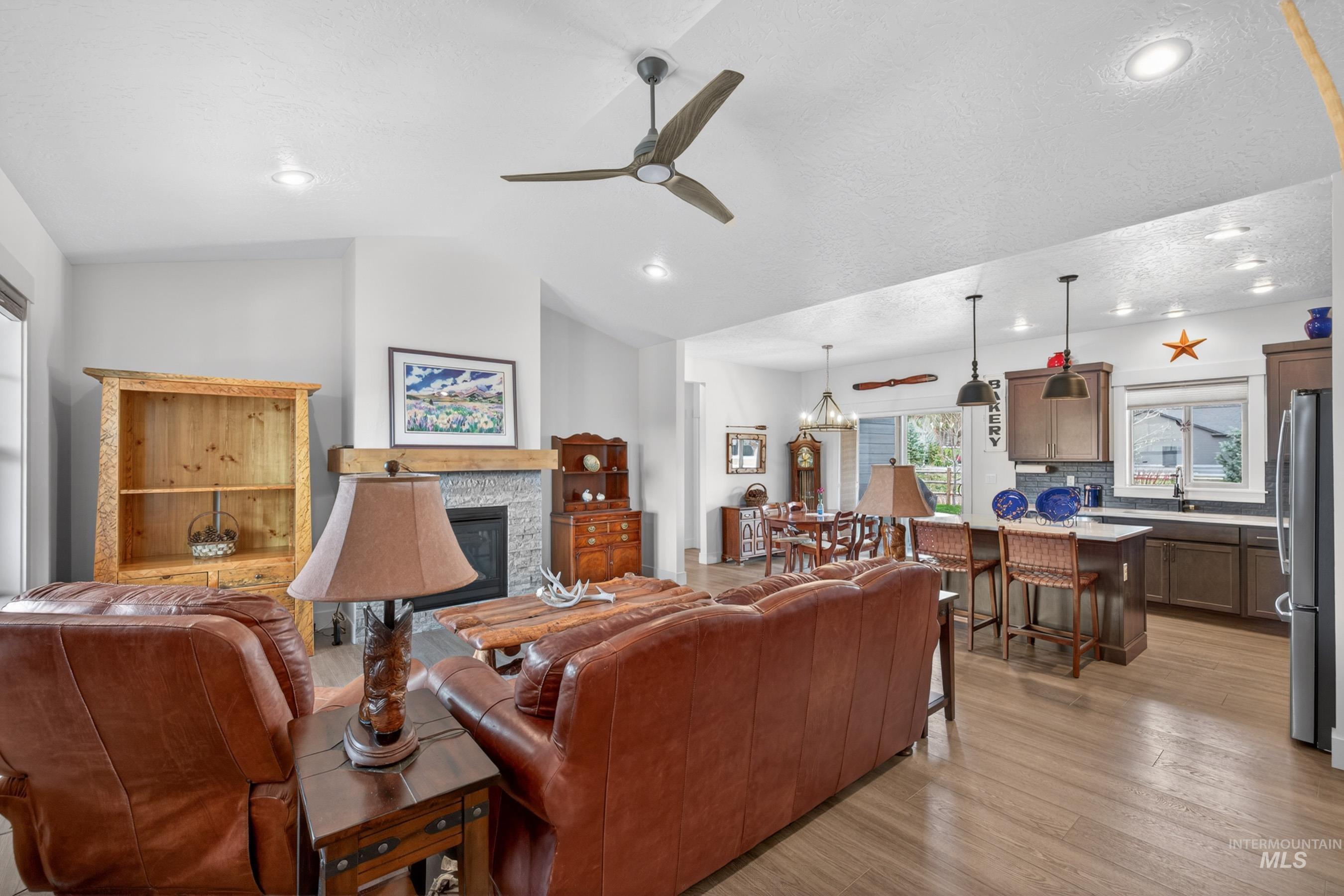 1126 Mo's Way McCall, ID 83638 - Photo 6 of 50 Open-concept living space featuring vaulted ceilings, recessed lighting, and wood-finish flooring