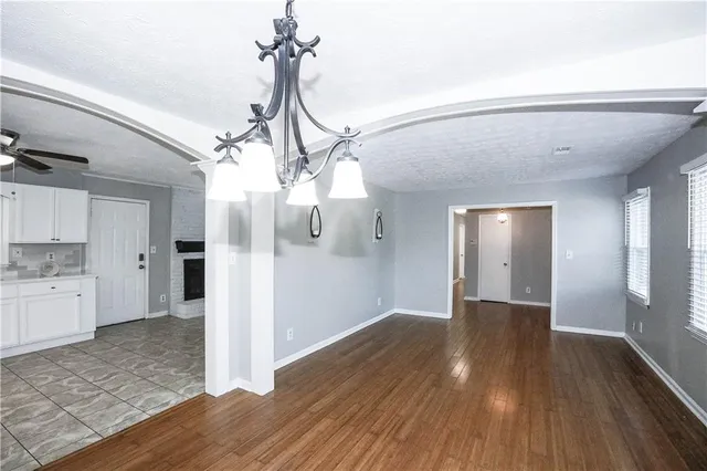 a view of a livingroom with wooden floor and a fireplace