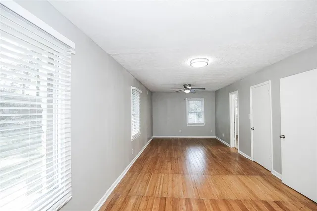 wooden floor in an empty room with a window