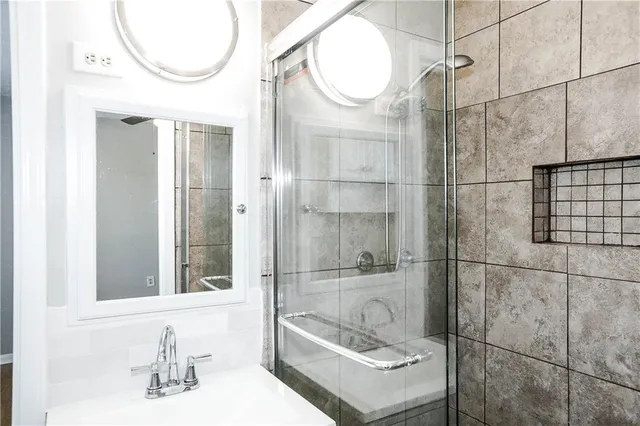 a bathroom with a sink toilet and shower