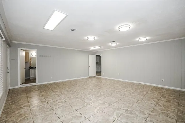 an empty room with windows and entrance