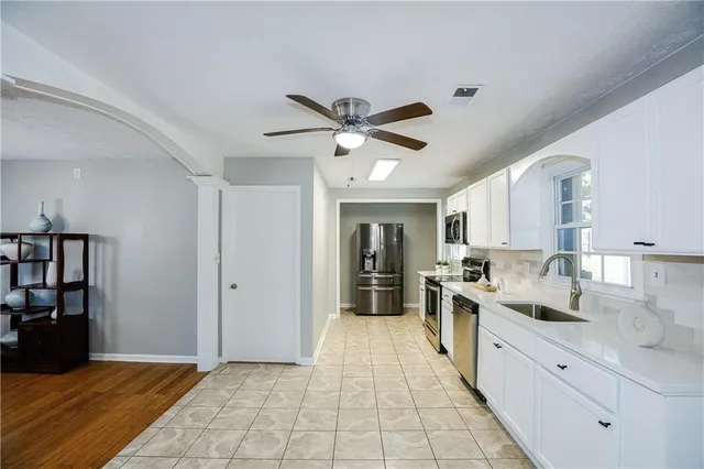 a kitchen with stainless steel appliances granite countertop a sink and cabinets