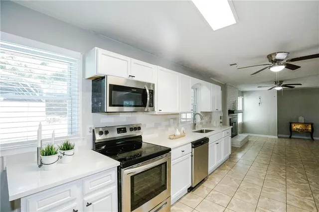 a kitchen with a sink a stove and microwave