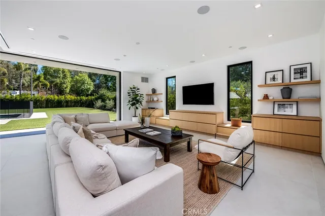 a living room with furniture and large flat screen tv
