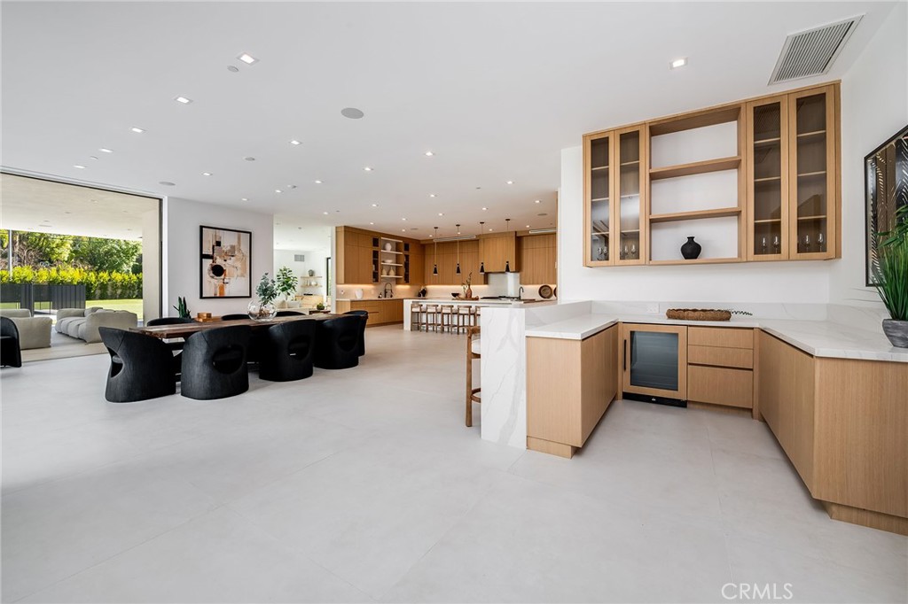 4930 Palomar Drive Tarzana, CA 91356 - Photo 11 of 43 a large kitchen with stainless steel appliances kitchen island a large counter top a sink a stove a refrigerator cabinets and a window