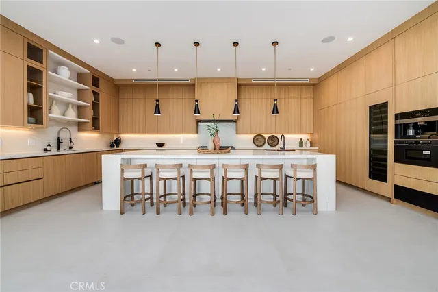 a kitchen with a table chairs sink and cabinets