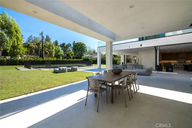 a view of a swimming pool with a table and chairs