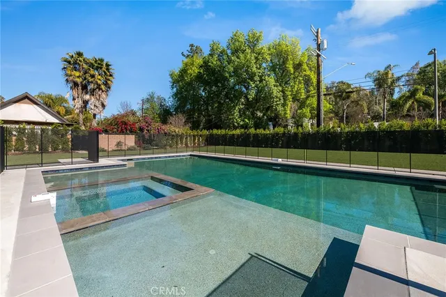 a view of a swimming pool with a yard