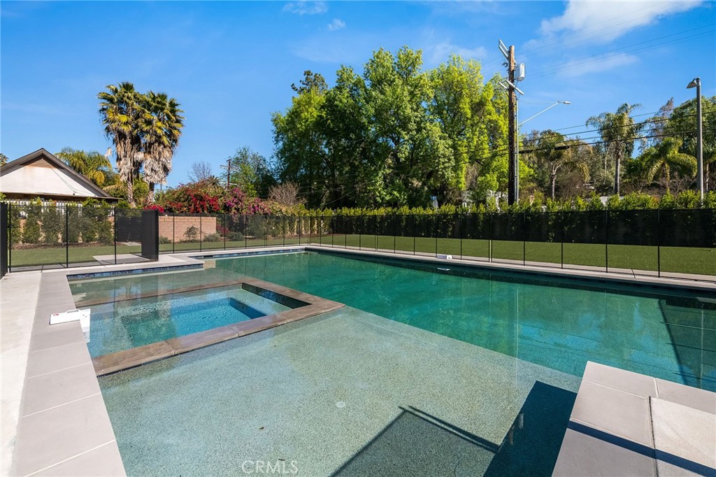4930 Palomar Drive Tarzana, CA 91356 - Photo 25 of 43 a view of a swimming pool with a yard