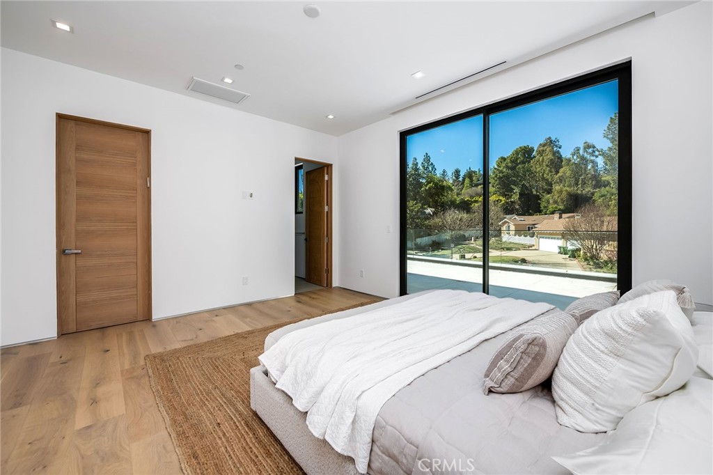 4930 Palomar Drive Tarzana, CA 91356 - Photo 29 of 43 a bedroom with a large bed and large window