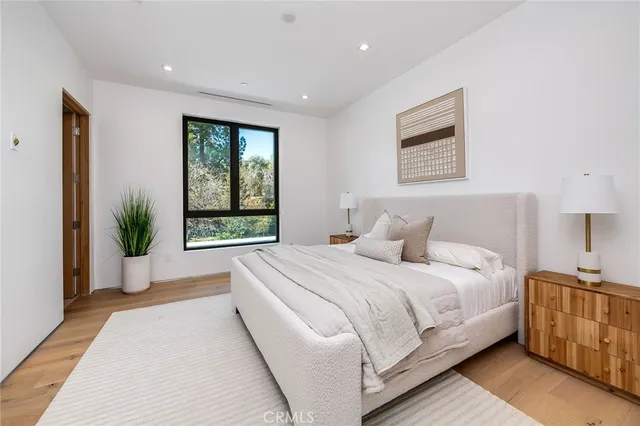 a bedroom with a bed and a chair