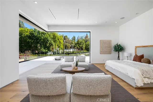 a spacious bedroom with a bed and a couch