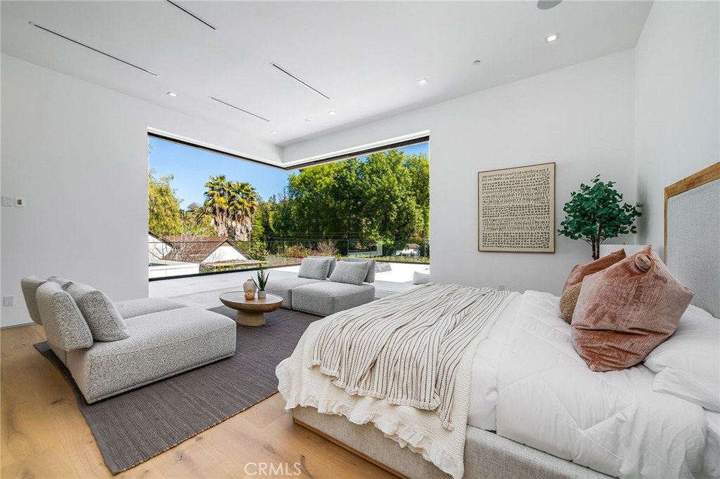 4930 Palomar Drive Tarzana, CA 91356 - Photo 37 of 43 a spacious bedroom with a bed and a couch