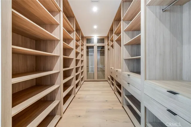 a view of walk in closet with empty racks