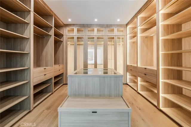a large white bathroom with a granite countertop sink mirror and bathtub