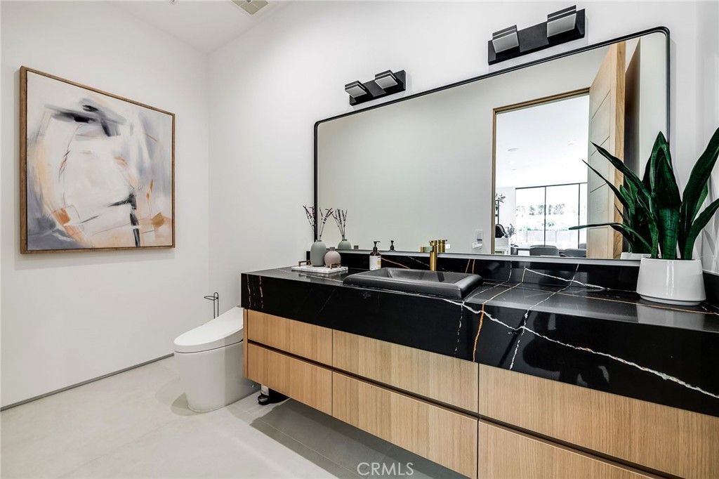 4930 Palomar Drive Tarzana, CA 91356 - Photo 42 of 43 a kitchen with a sink and a large mirror