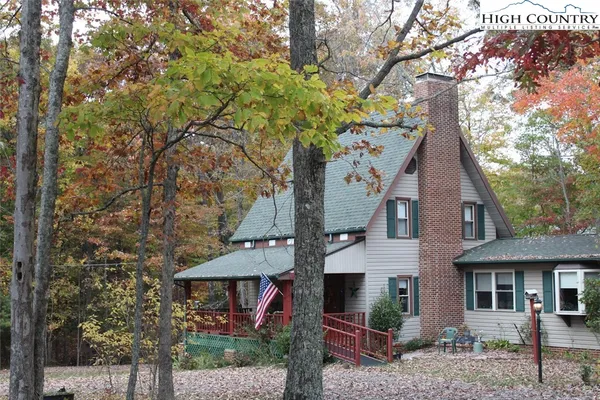 a view of house with a tree in front of it