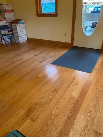 a view of a room with wooden floor and window
