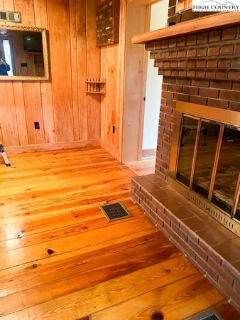 a view of a balcony with wooden floor and fence