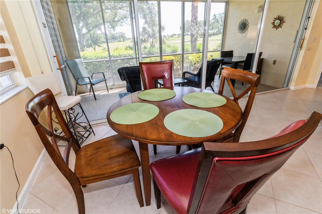 3010 Meandering Way, Unit 101 Fort Myers, FL 33905 - Photo 13 of 37 a dining room with furniture a rug and wooden floor