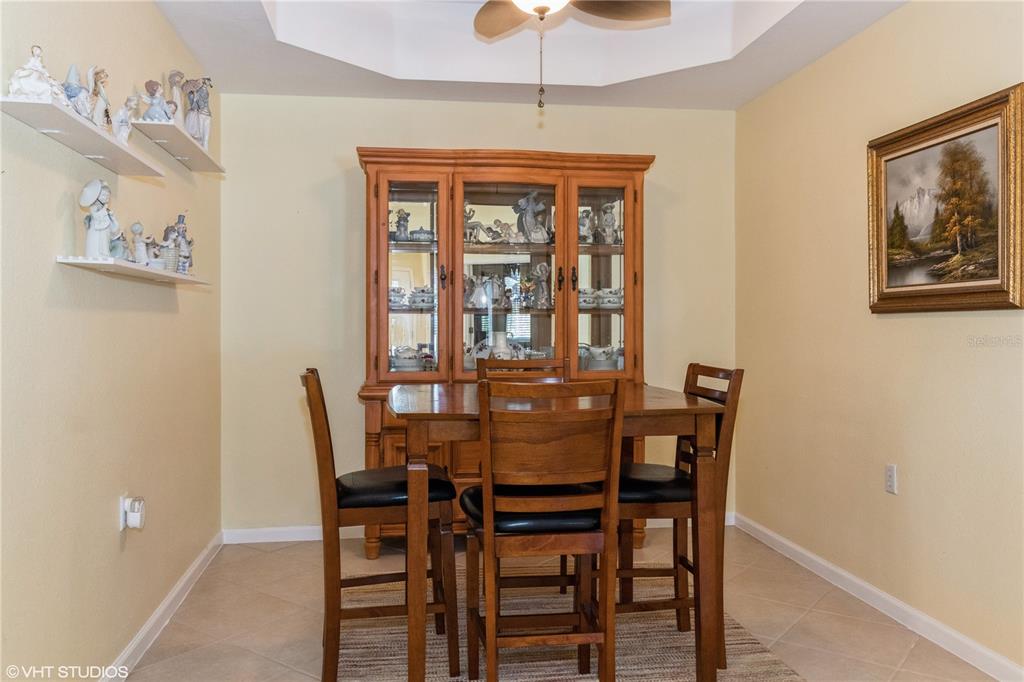 3010 Meandering Way, Unit 101 Fort Myers, FL 33905 - Photo 15 of 37 a view of a dining room with furniture and chandelier