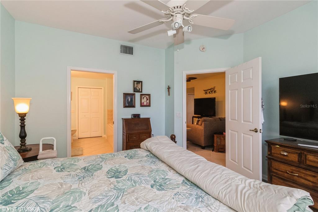 3010 Meandering Way, Unit 101 Fort Myers, FL 33905 - Photo 21 of 37 a bedroom with a bed and a flat screen tv