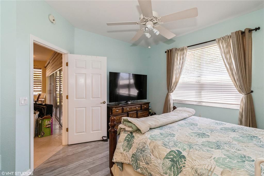 3010 Meandering Way, Unit 101 Fort Myers, FL 33905 - Photo 22 of 37 a bedroom with a bed and a flat screen tv