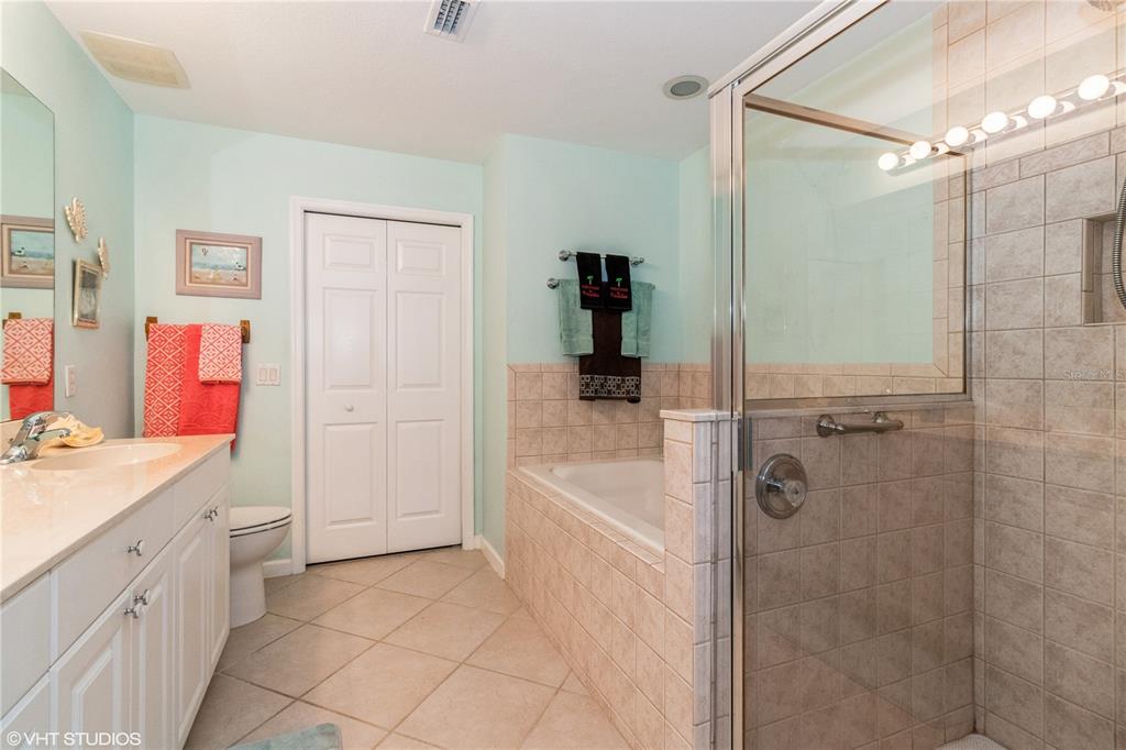 3010 Meandering Way, Unit 101 Fort Myers, FL 33905 - Photo 23 of 37 a bathroom with a sink vanity granite tub shower and mirror