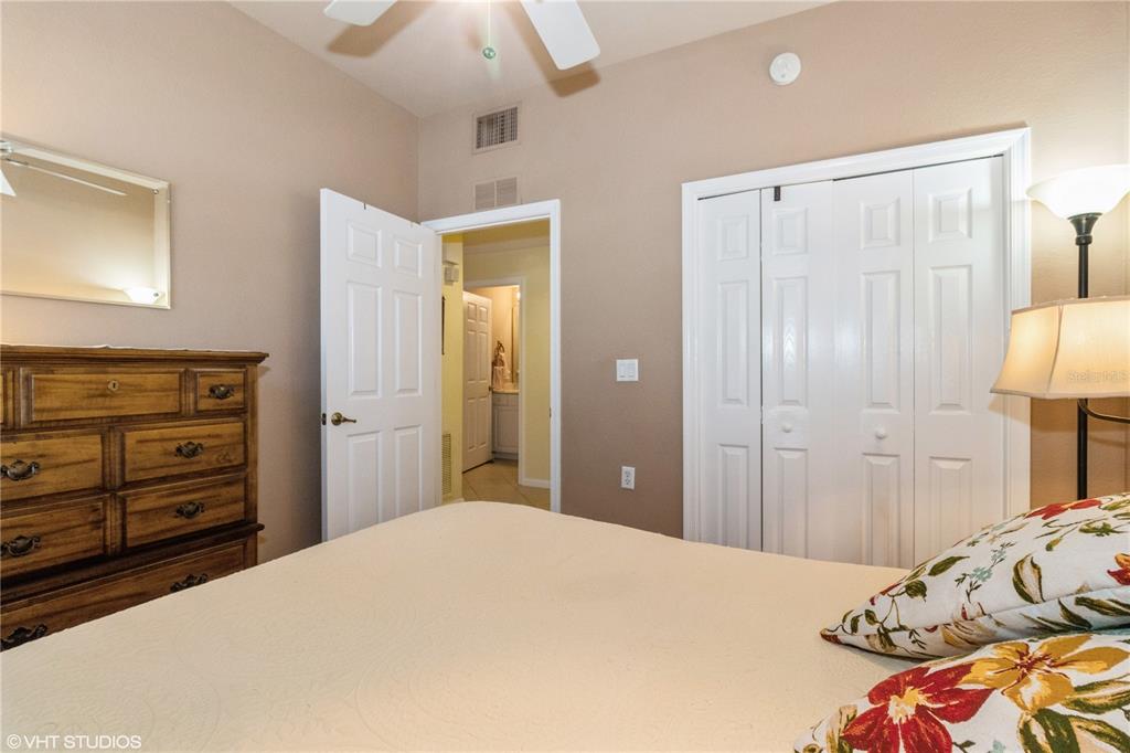 3010 Meandering Way, Unit 101 Fort Myers, FL 33905 - Photo 26 of 37 a bedroom with a bed and a dresser