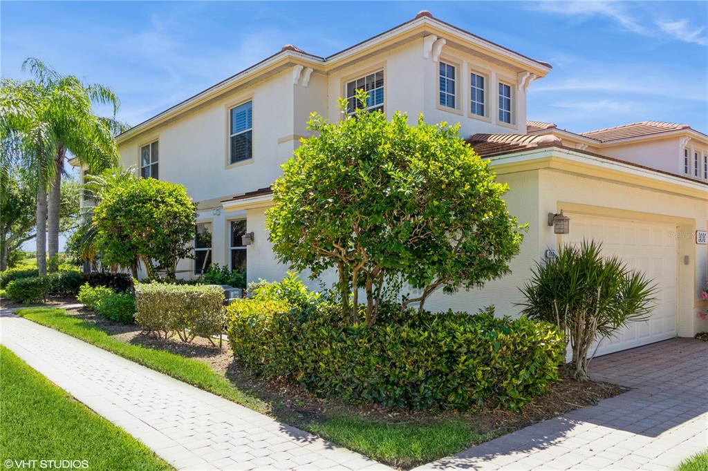 3010 Meandering Way, Unit 101 Fort Myers, FL 33905 - Photo 30 of 37 a front view of a house with a yard