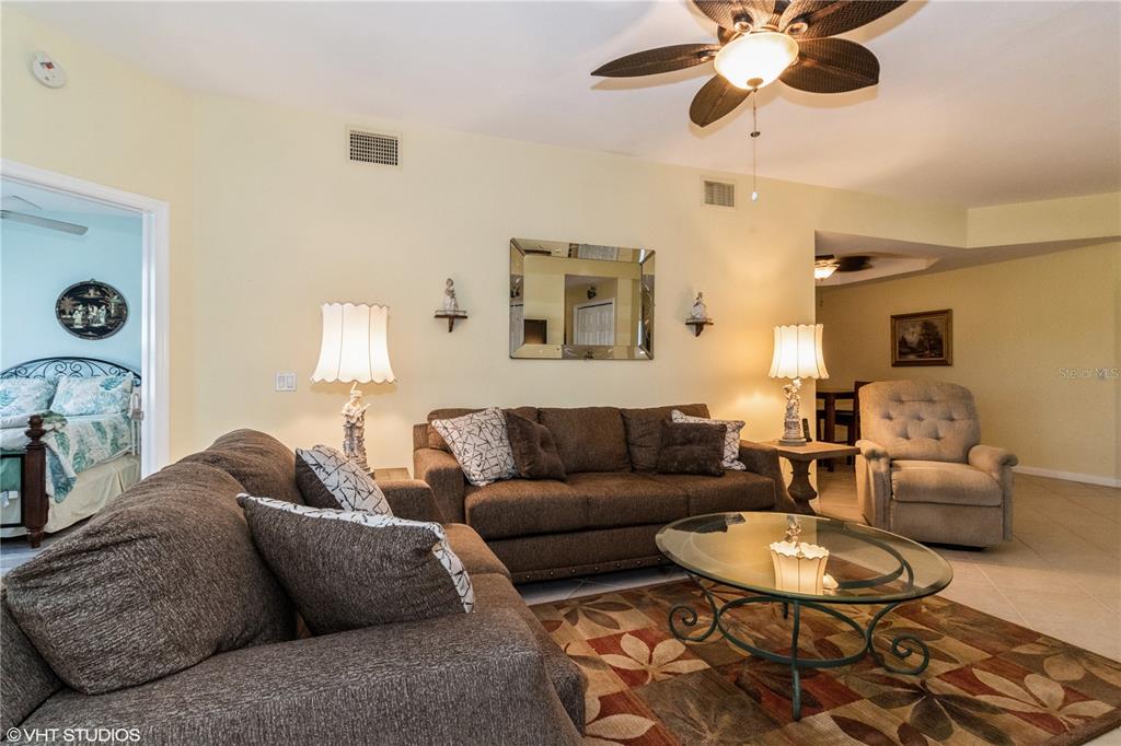 3010 Meandering Way, Unit 101 Fort Myers, FL 33905 - Photo 9 of 37 a living room with furniture kitchen view and a window
