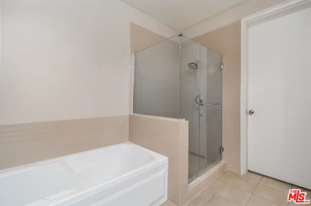 a bathroom with a bathtub and shower