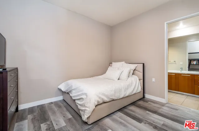 a bedroom with a bed and a night stand