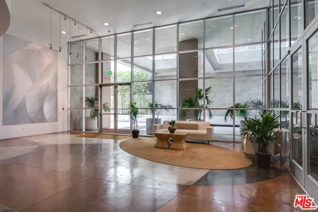 a living room with glass door and furniture