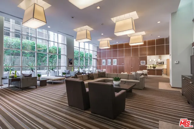 a living room with furniture a lamp and a floor to ceiling window