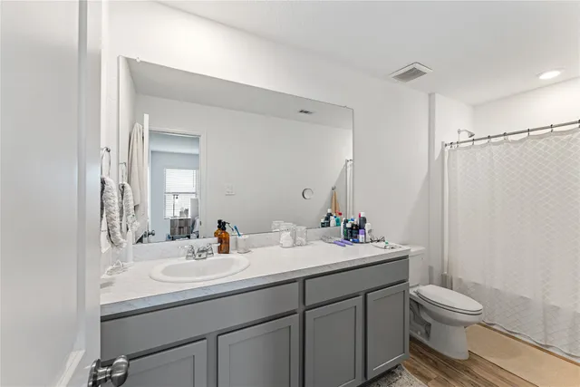 a bathroom with a sink toilet a mirror and shower