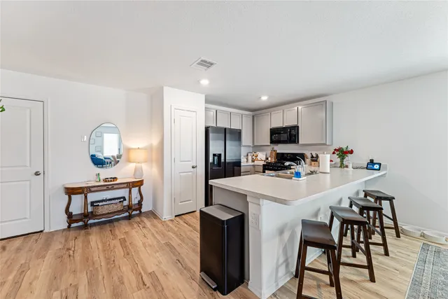 a kitchen that has a table and chairs in it