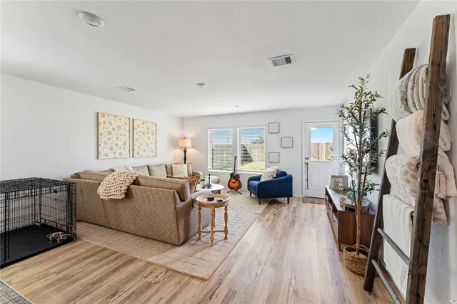 a living room with fireplace furniture and a flat screen tv