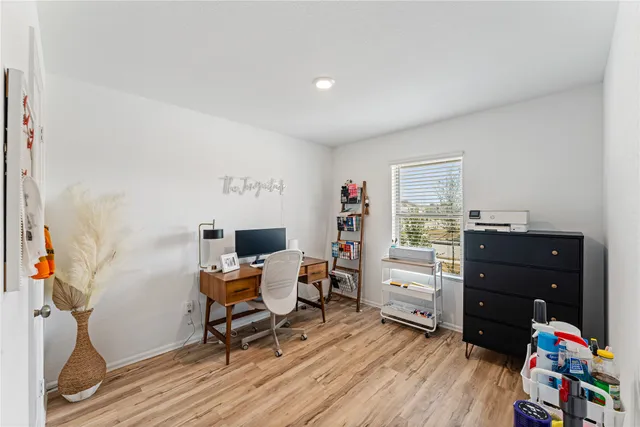 a view of a workspace with furniture and a window