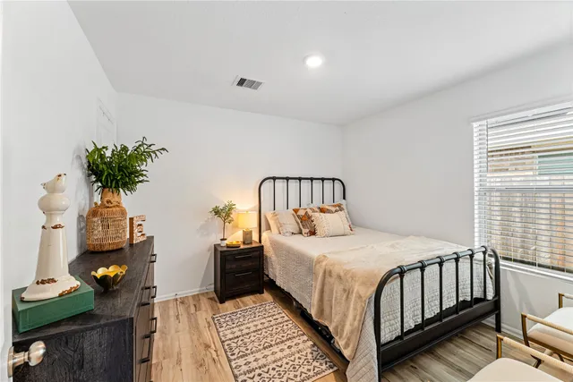 a bedroom with bed and a potted plant
