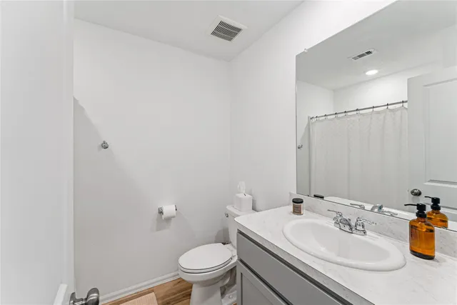 a bathroom with a sink toilet and a mirror