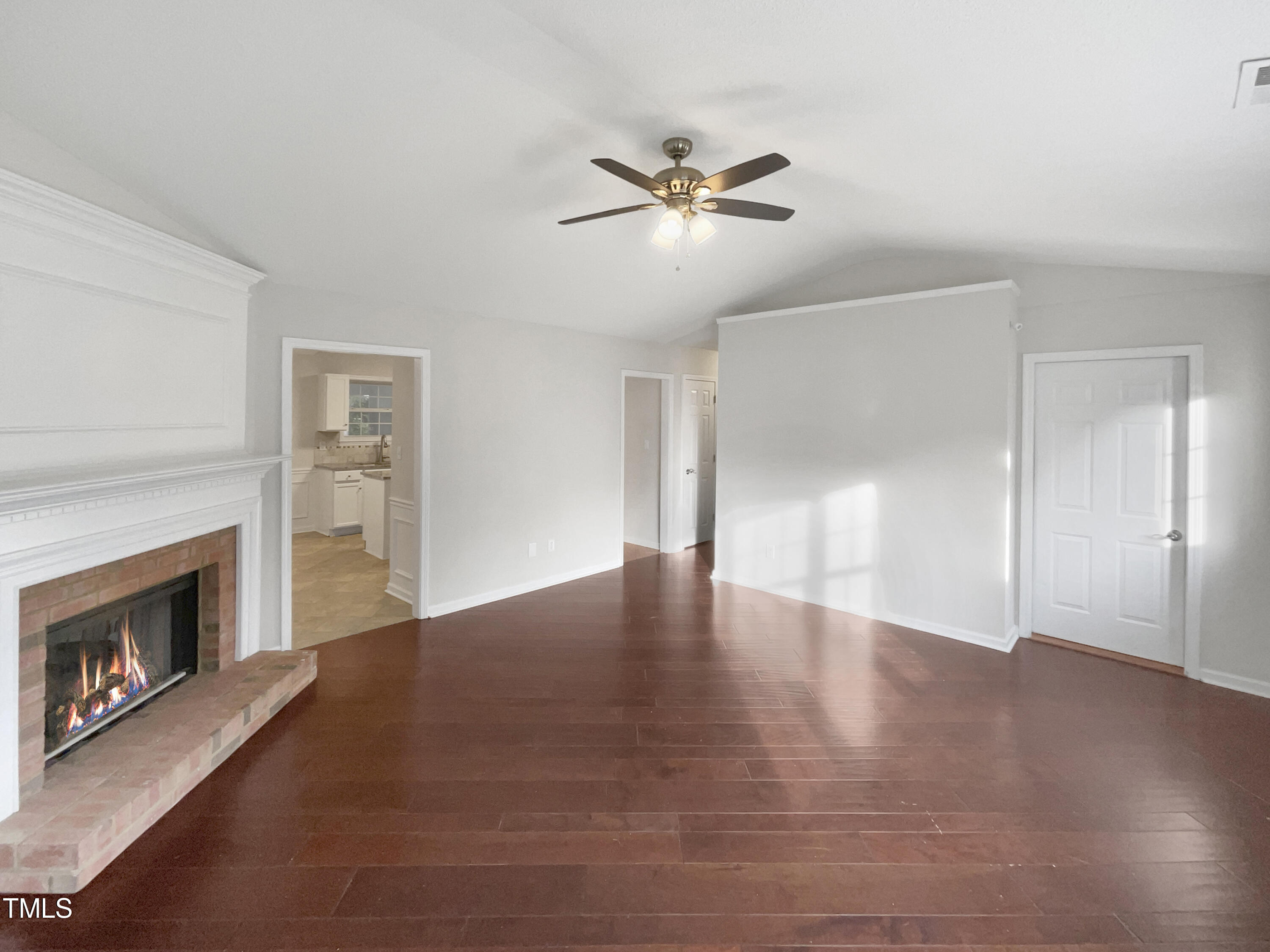 11 Windsor Glen Drive Durham, NC 27703 - Photo 11 of 29 a view of an empty room with wooden floor fireplace and a window