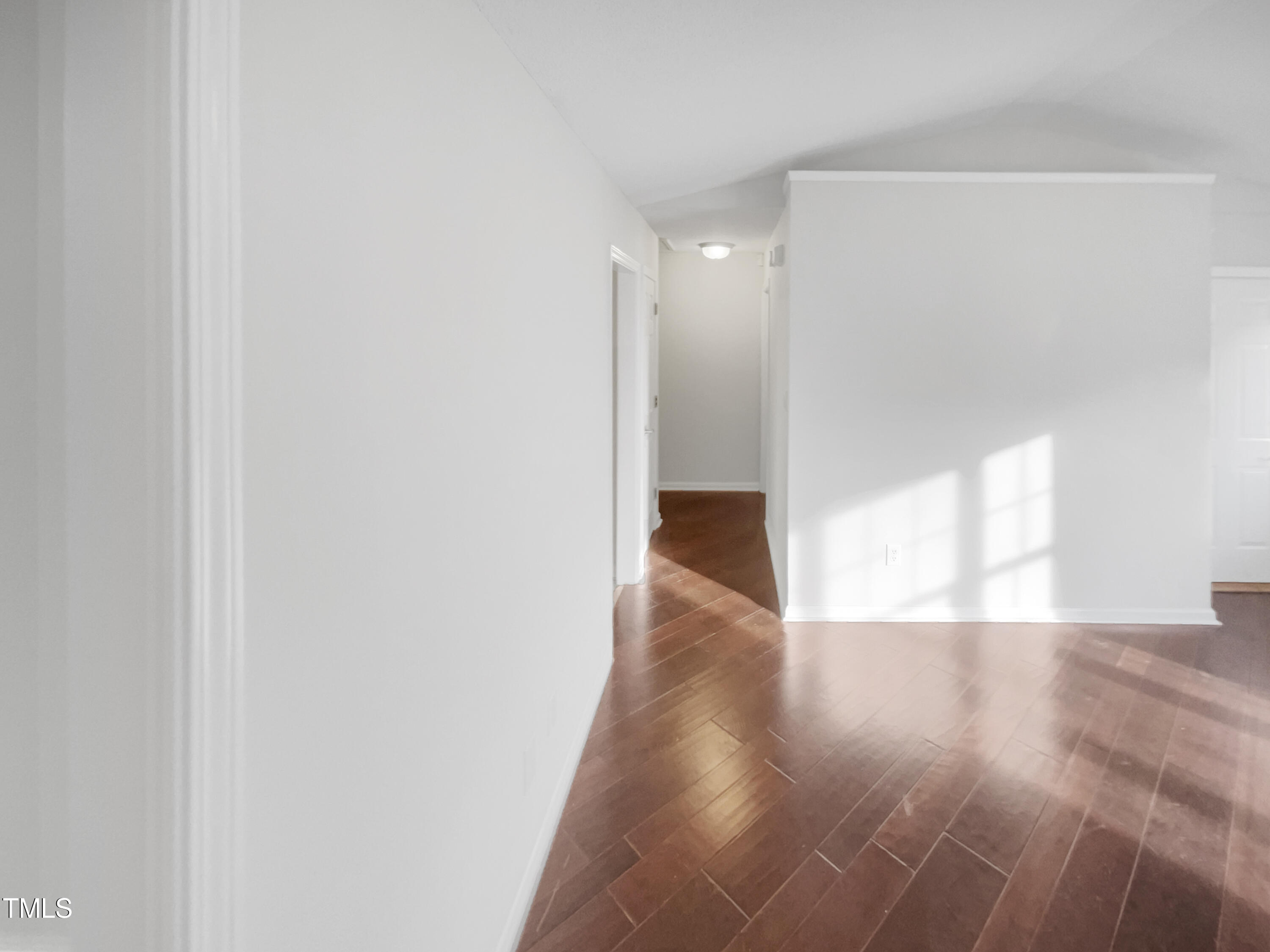 11 Windsor Glen Drive Durham, NC 27703 - Photo 12 of 29 a view of an empty room with wooden floor and a window