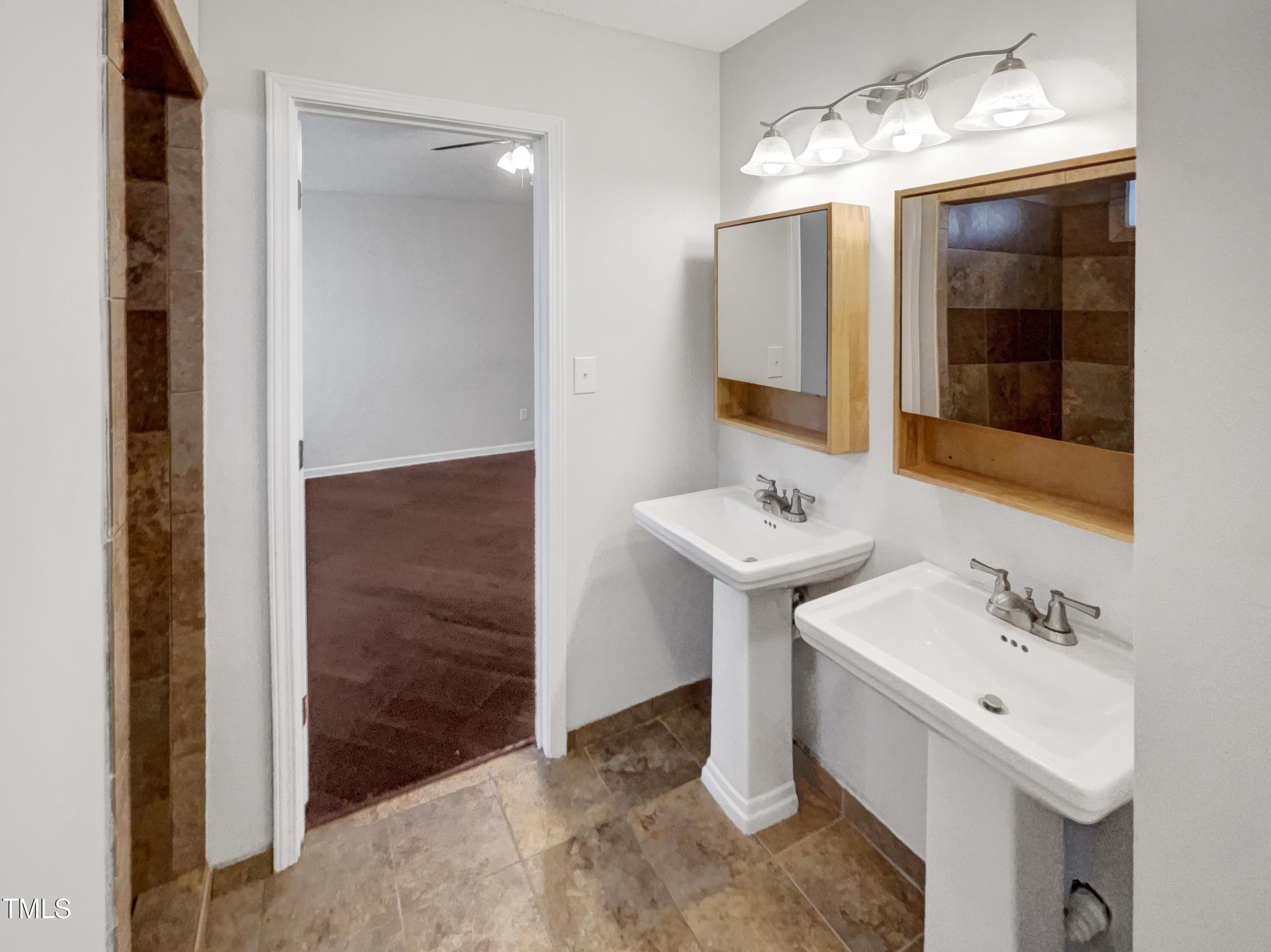11 Windsor Glen Drive Durham, NC 27703 - Photo 22 of 29 a bathroom with a sink and a mirror